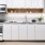 a kitchen with white cabinets and ample lighting